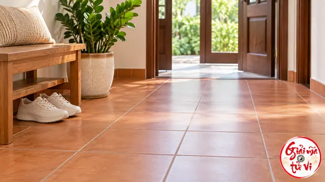Lối hành lang lát gạch thông thoáng, đôi giày đặt dưới ghế và logo Giải Mã Tử Vi ở góc dưới phải